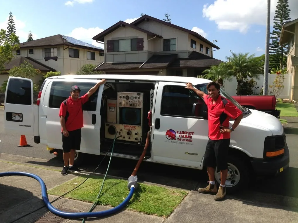 AAA Water Damage technicians with a truck-mounted extraction van on a Honolulu residential street